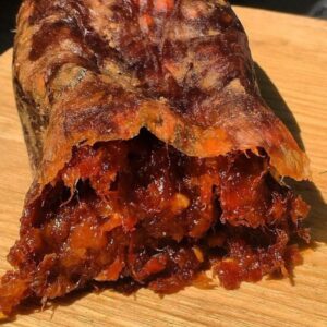 juicy dark red and orange loose textured chilli salami, open and overflowing lavishly